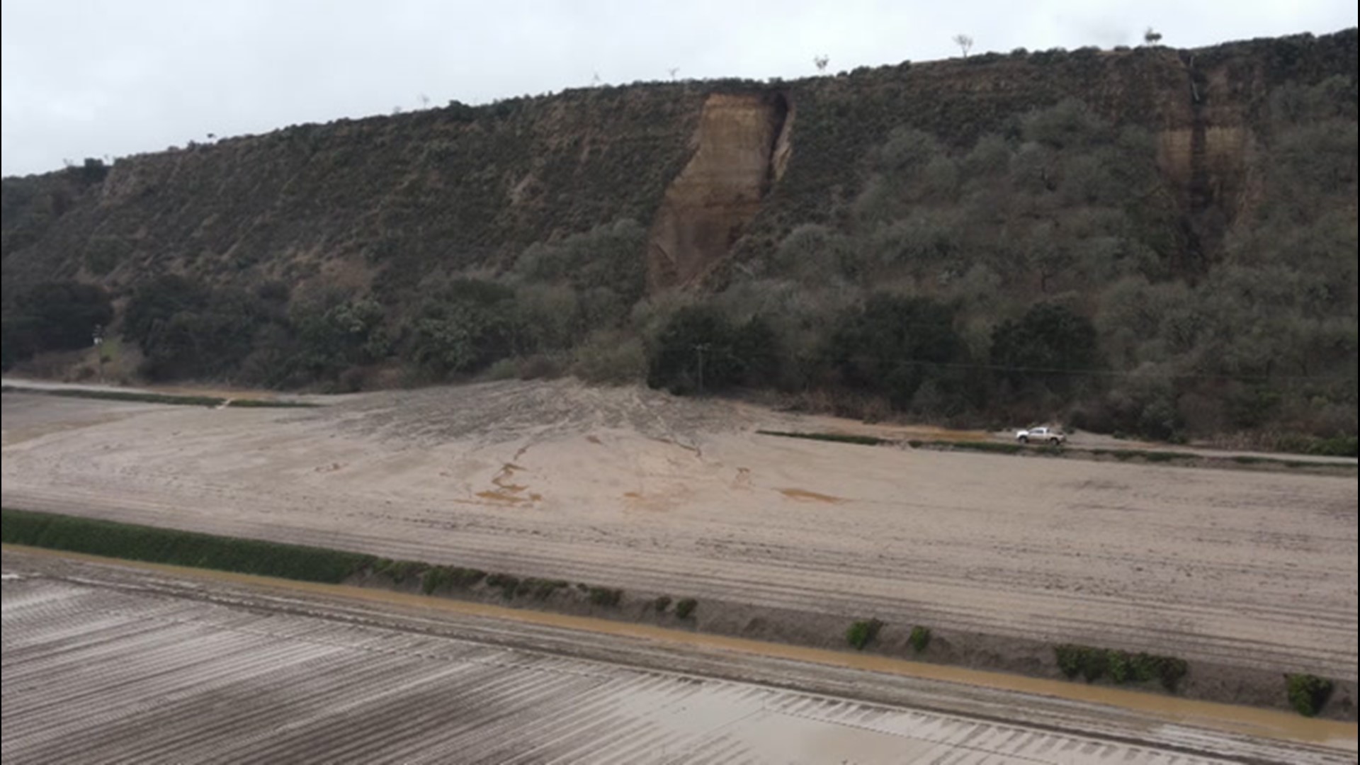 Drone shots show a debris flow covering River Road after heavy rains near Soledad, California.