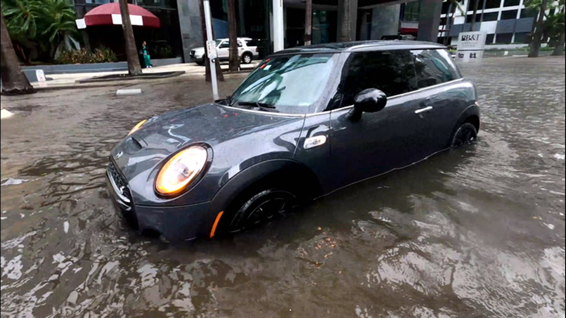 Cars flow through flooded streets of Miami