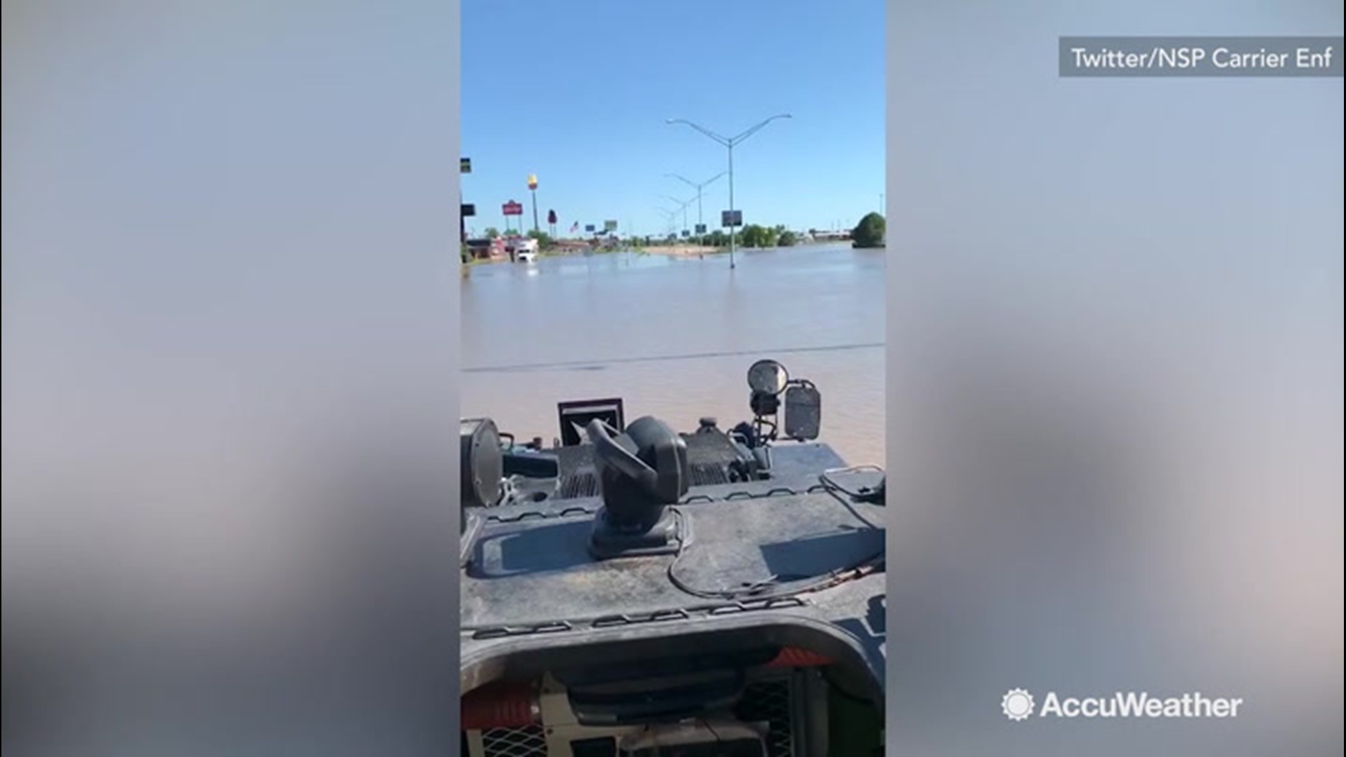 Police on motorboats surveyed the damage done by flash flooding in Kearney, Nebraska on July 9.