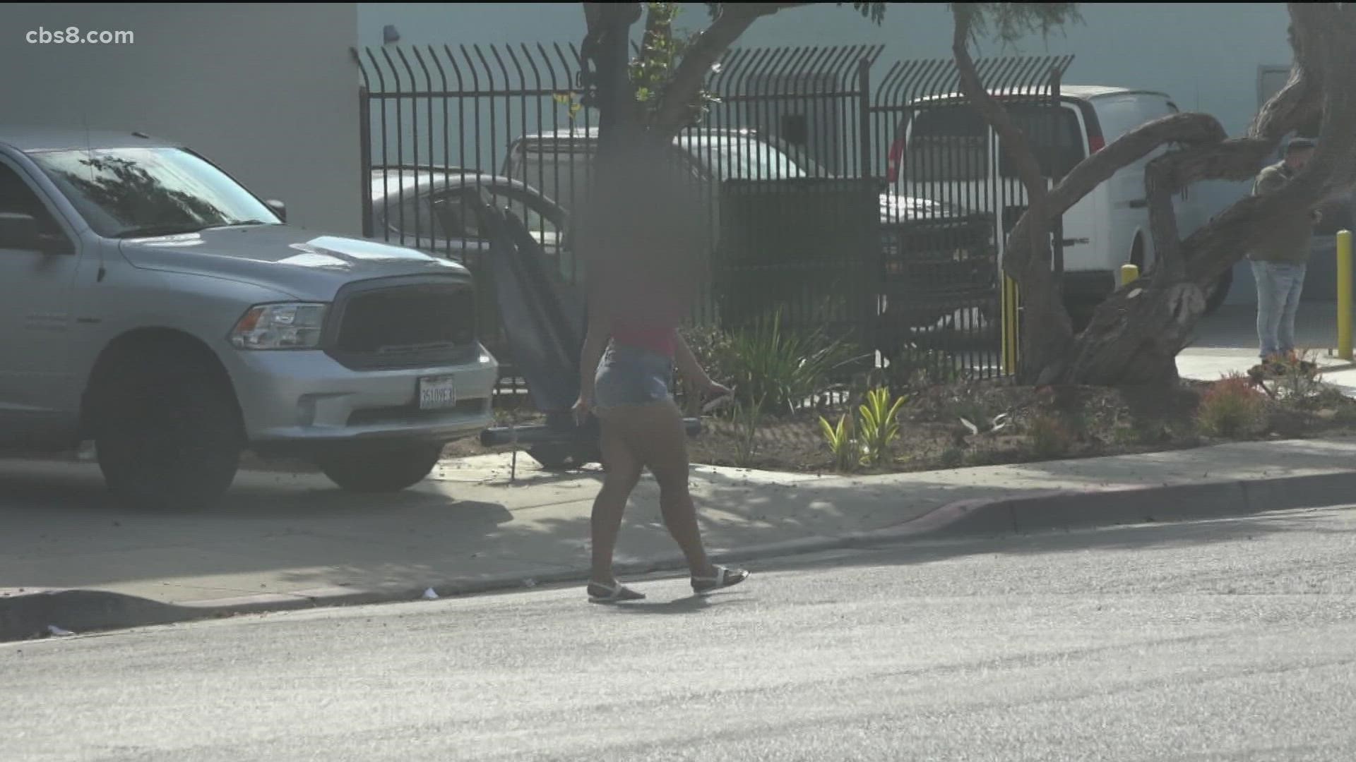 Girl walks down the street in a sexy way while being recorded