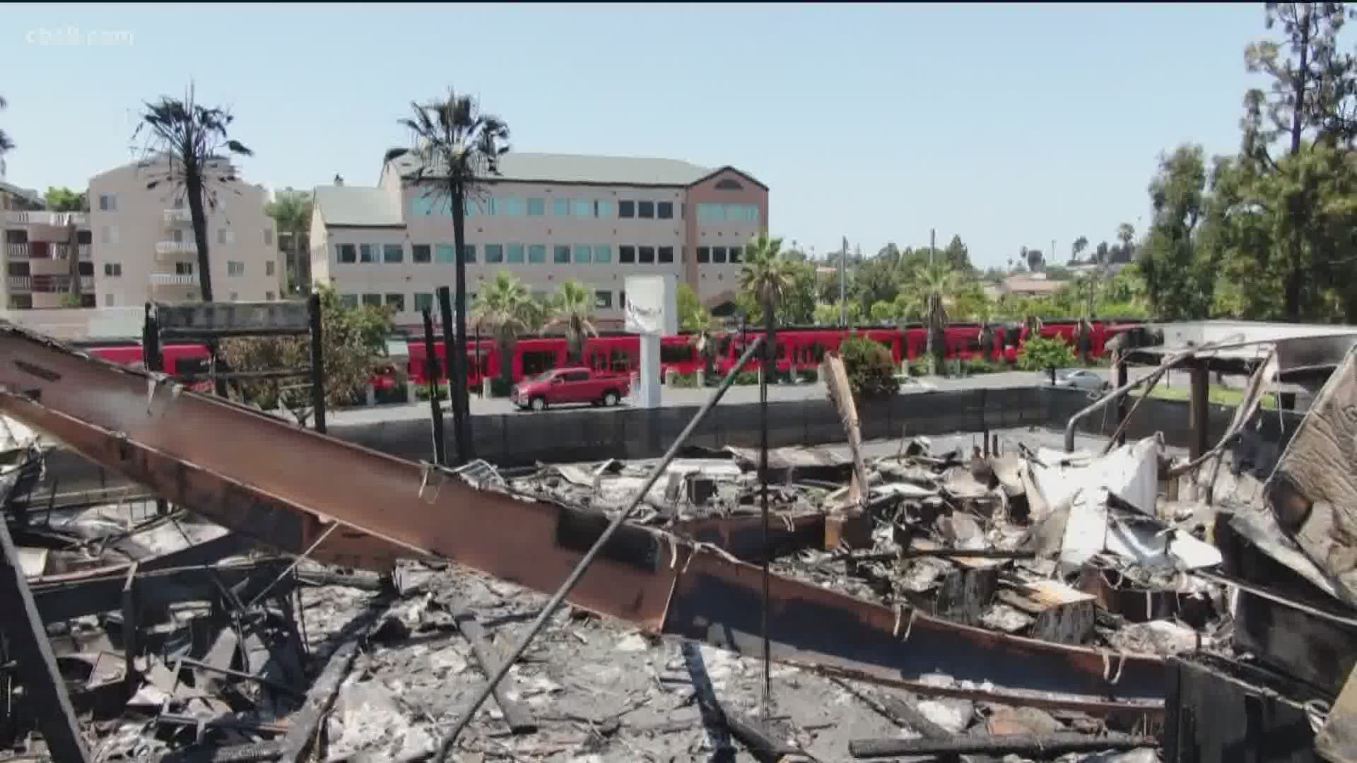 “The buildings you see behind me have been burned down by those who do not represent the black community," said activist Rev. Shane Harris.