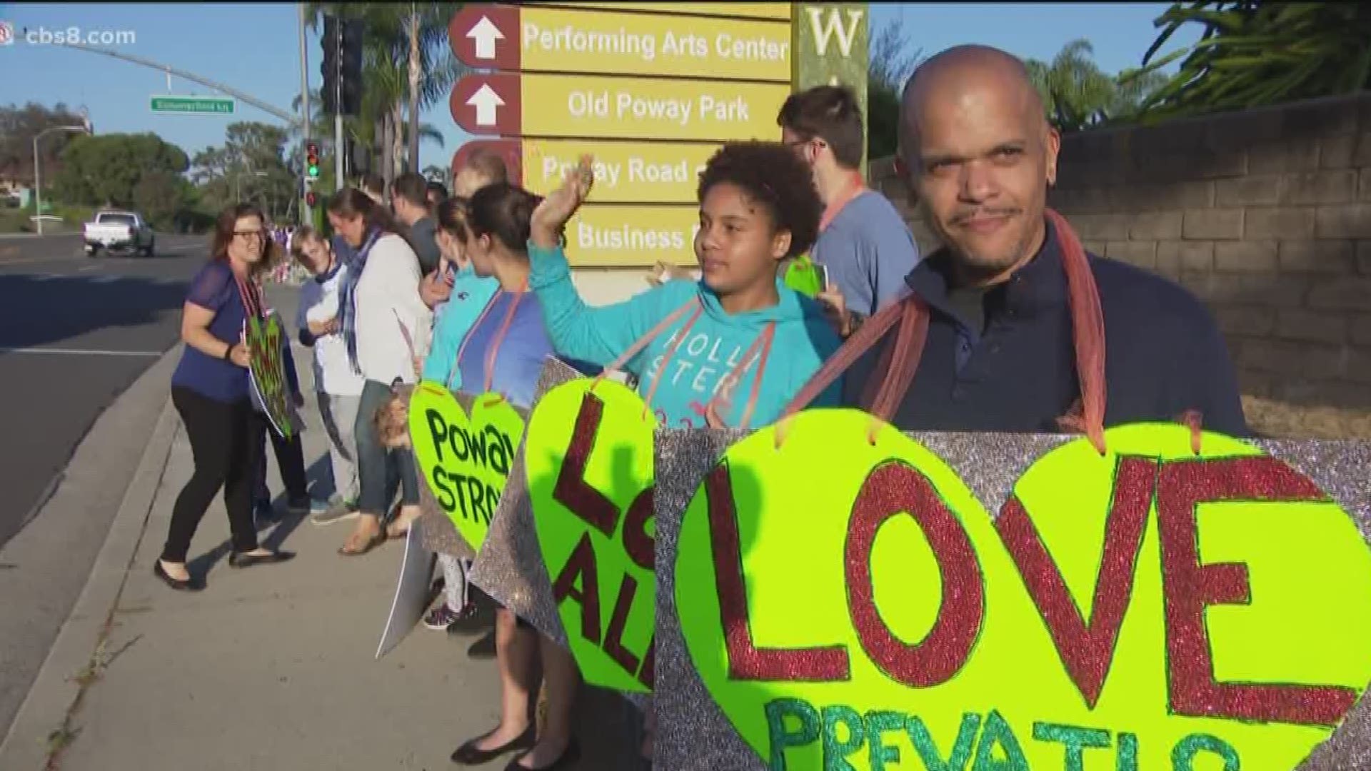 Organized by a group called 'Moms of Poway,' community members of all ages and religions waved handmade signs, some saying "Poway Strong" and "Love All."