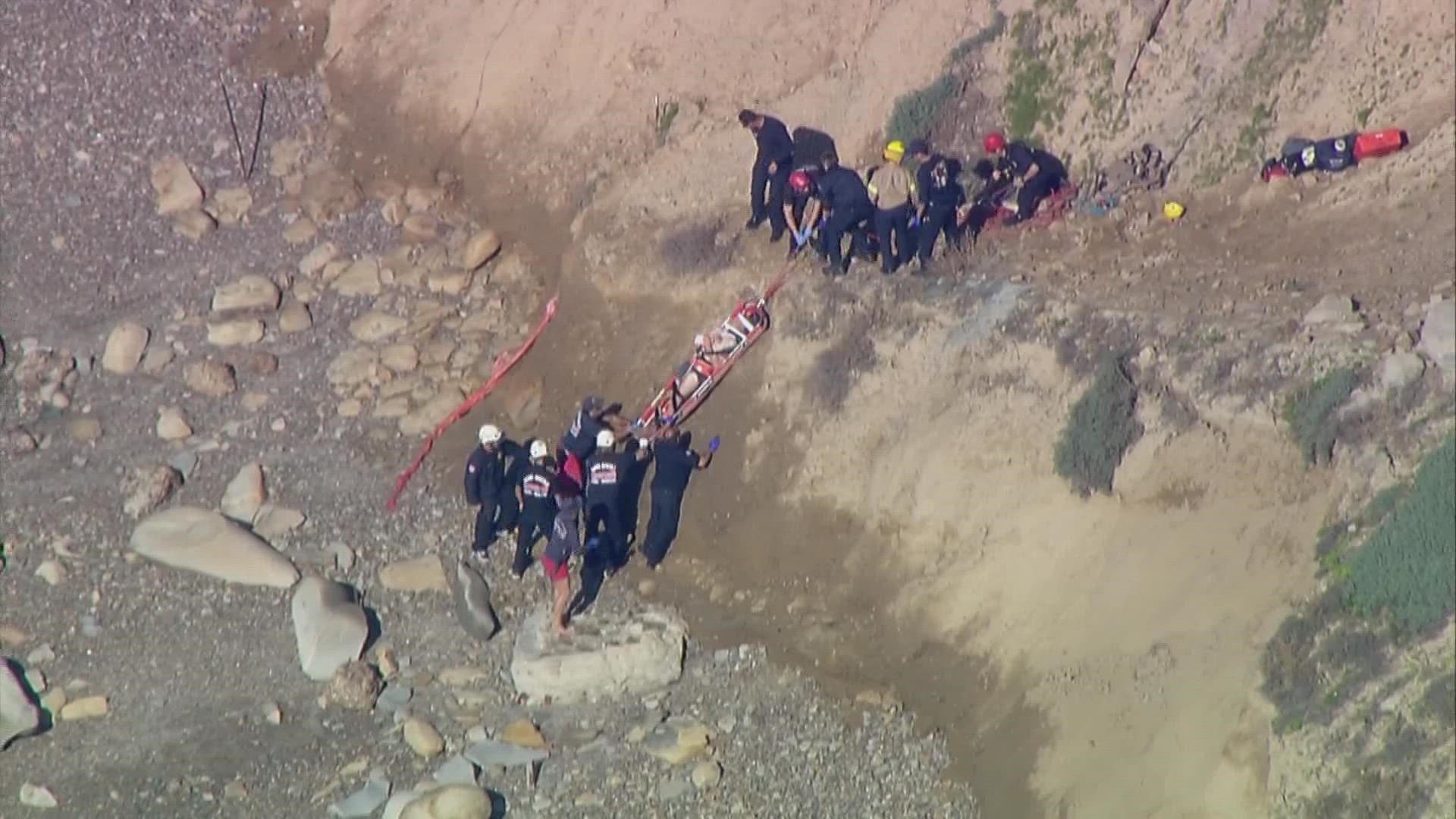 San Diego Fire-Rescue Department launched a rescue operation for a man who reportedly fell over 50 feet off a Torrey Pines cliffside Monday afternoon.