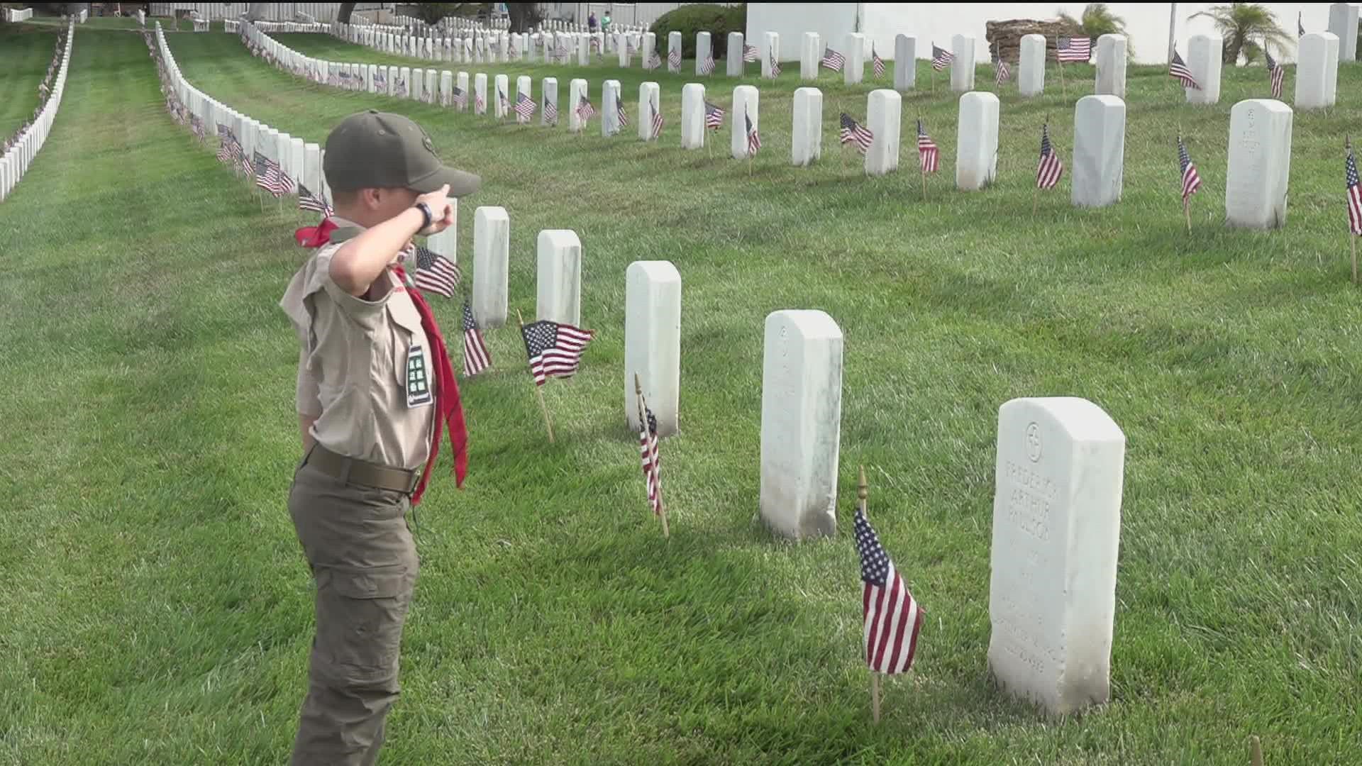 San Diego boy scouts, girl scouts and volunteers placed American flags on the tombstones of those who once served our country.