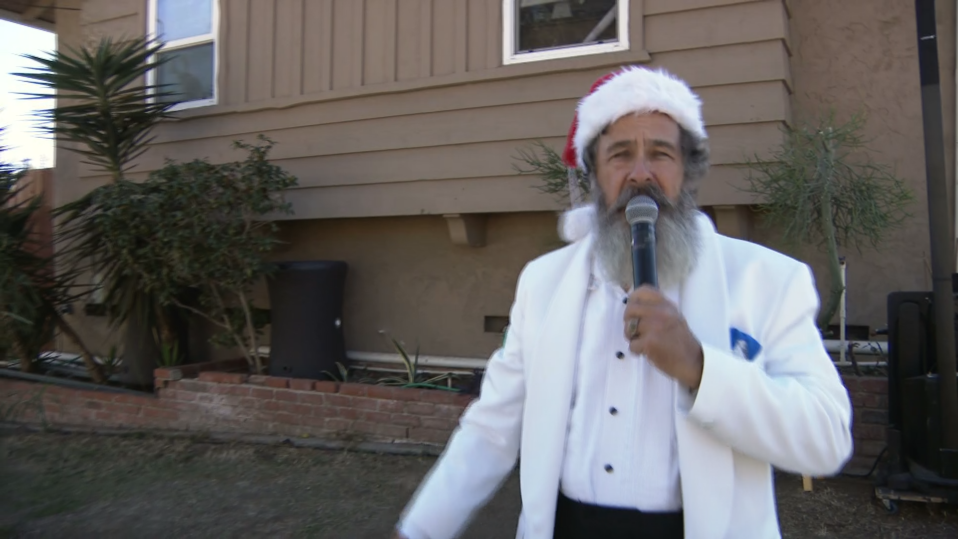 COVID put the Sinatra-style singer out of work so he grew out a Santa beard and kept on singing!
