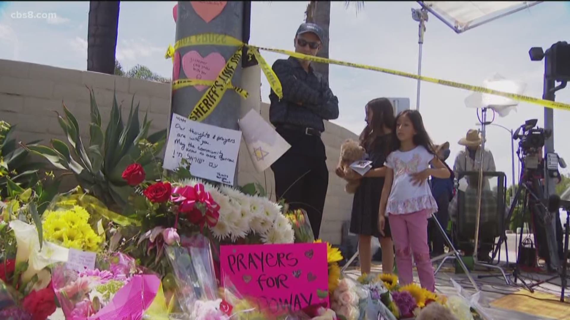 On Sunday, a constant flow of people dropped off small offerings and messages of support at a makeshift memorial across the street from the synagogue.