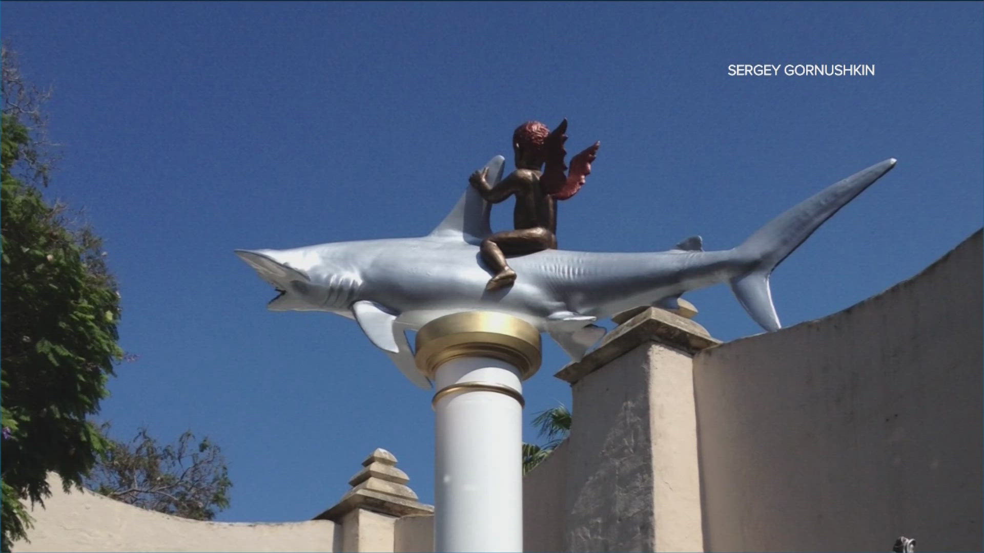 The fiberglass sculpture of cupid riding a hammerhead shark will stand on a column 15-feet above the ground in the skateboarding area of the park.