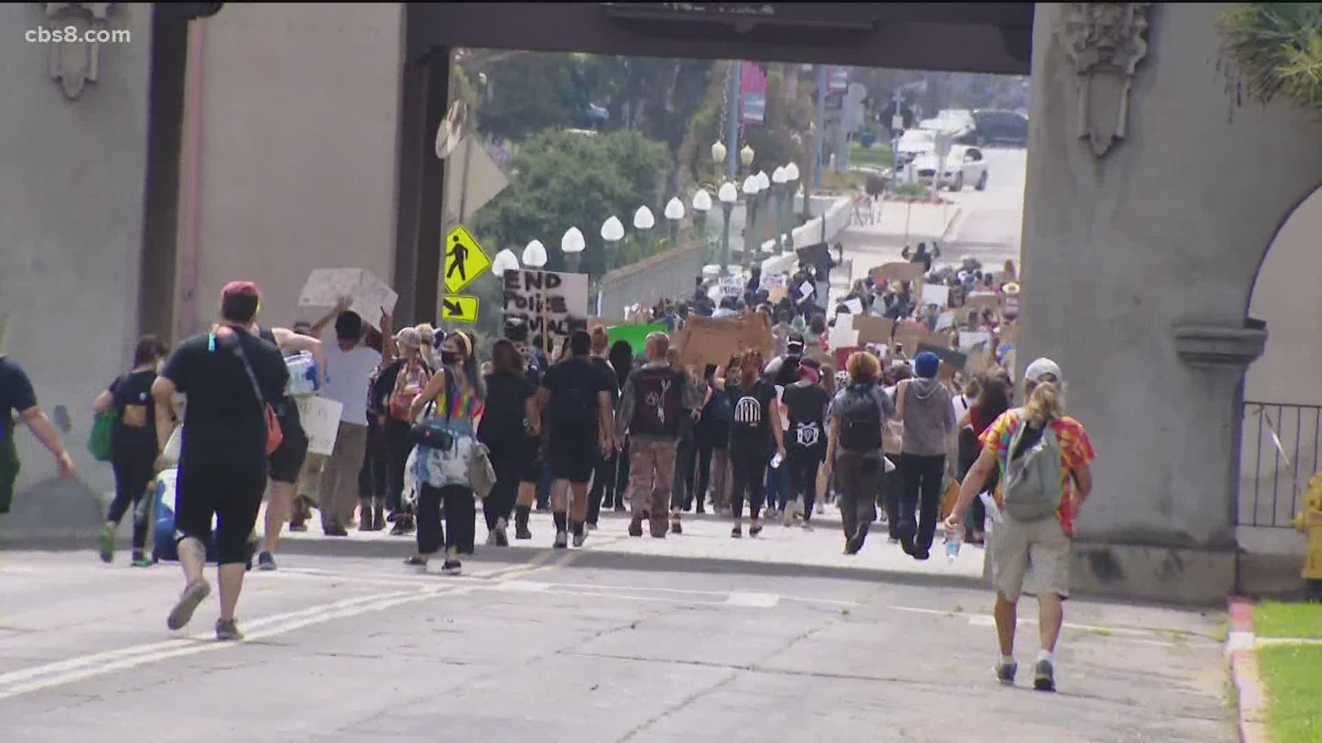 Balboa Park protesters chanted to police "march with us" while passing a group of officers along El Prado as they made their way toward the Cabrillo Bridge.