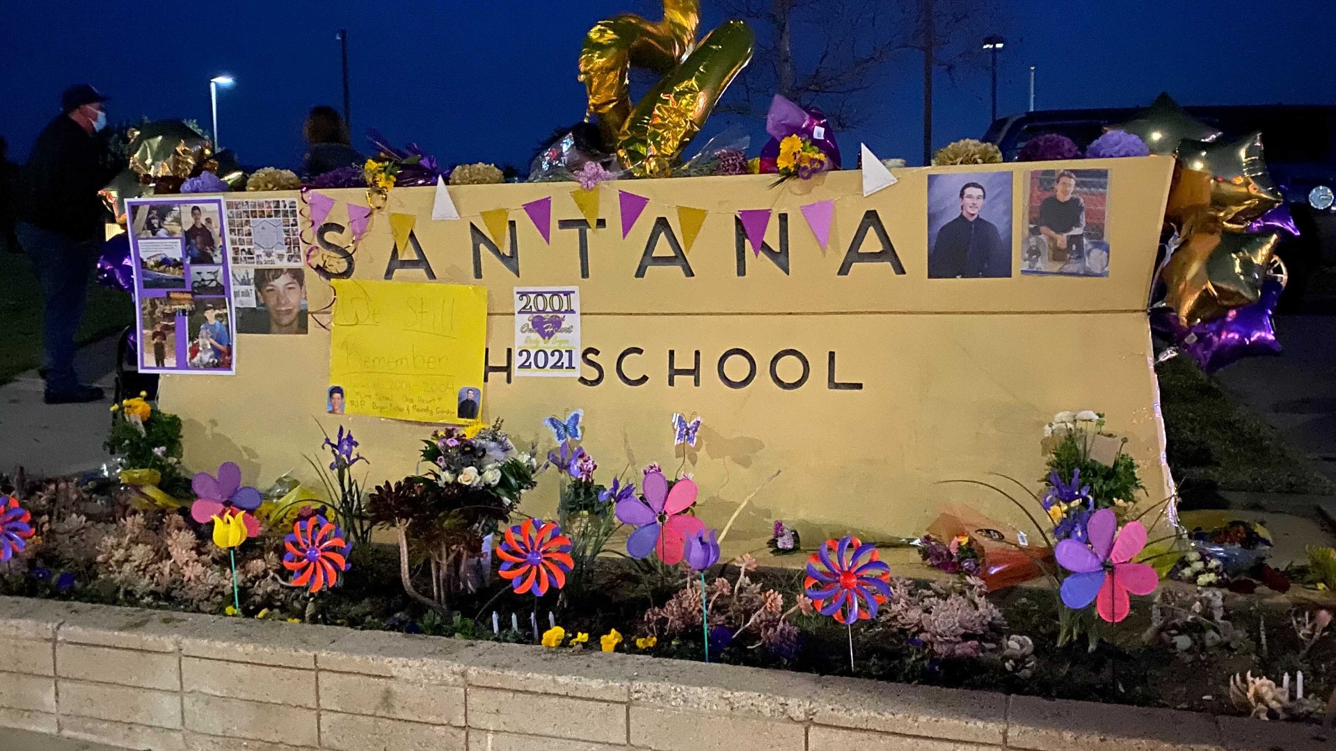 About 100 people attended a vigil outside Santana High School in Santee Friday night to honor the victims and survivors of the deadly 2001 school shooting.