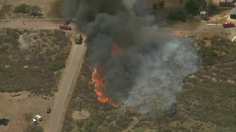 Fire crews battle vegetation fire burning east of Ramona in Witch Creek
