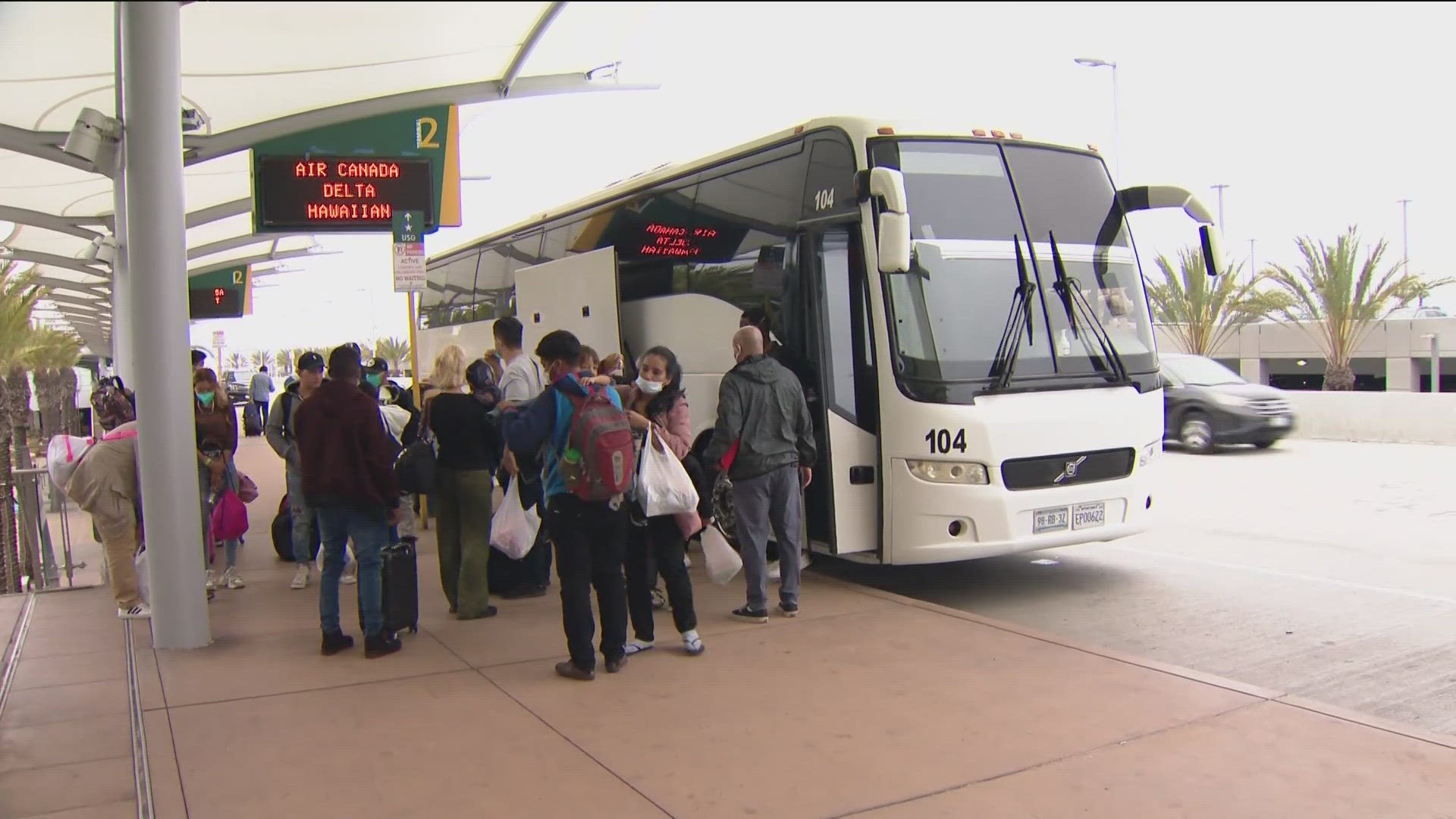 Buses loaded with dozens of processed migrants were dropped off at the San Diego International Airport.