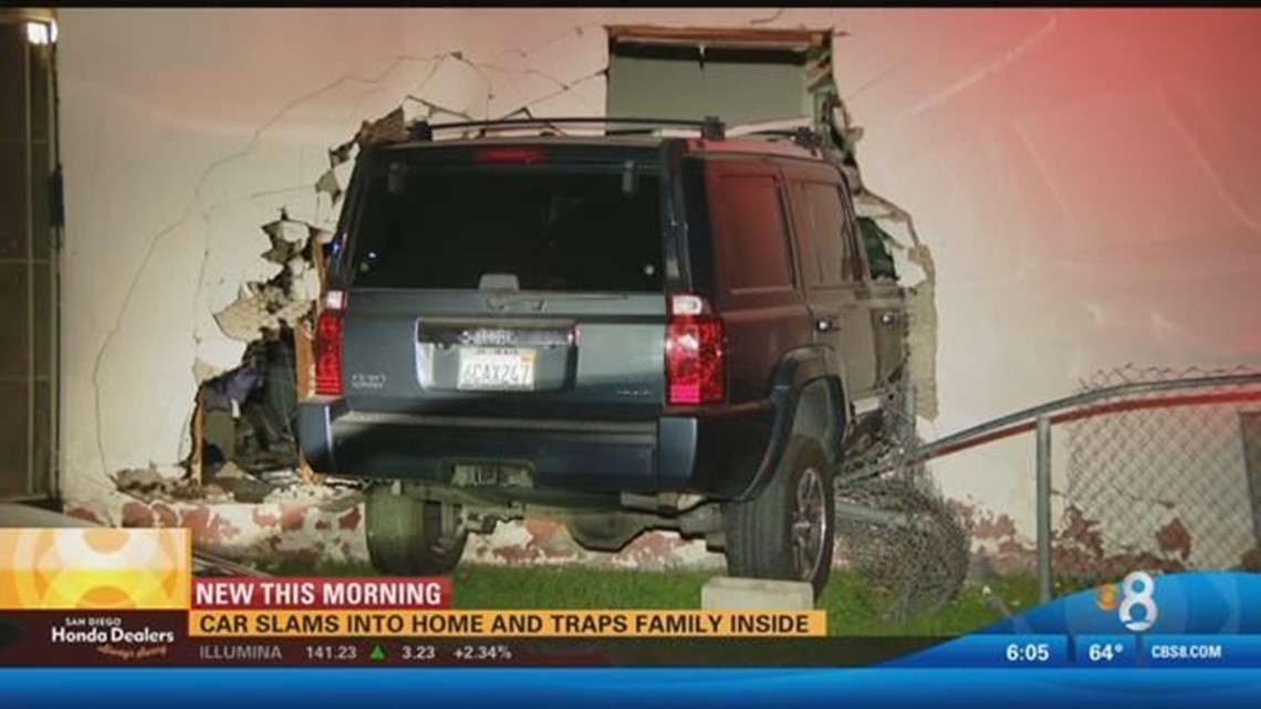 Car slams into home and traps family inside | cbs8.com