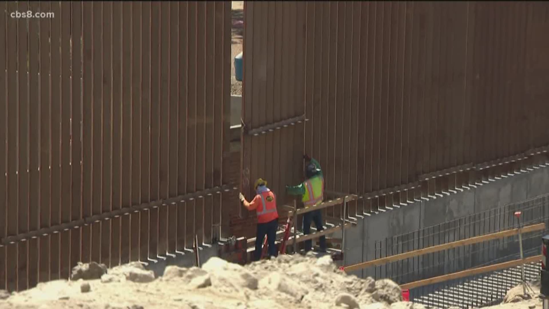 The border wall in Otay Mesa was completed on Friday as crews installed the final panel of that section. The section of fencing stretches from near the Pacific Ocean to Otay Mountain and is double the height of the old fencing.