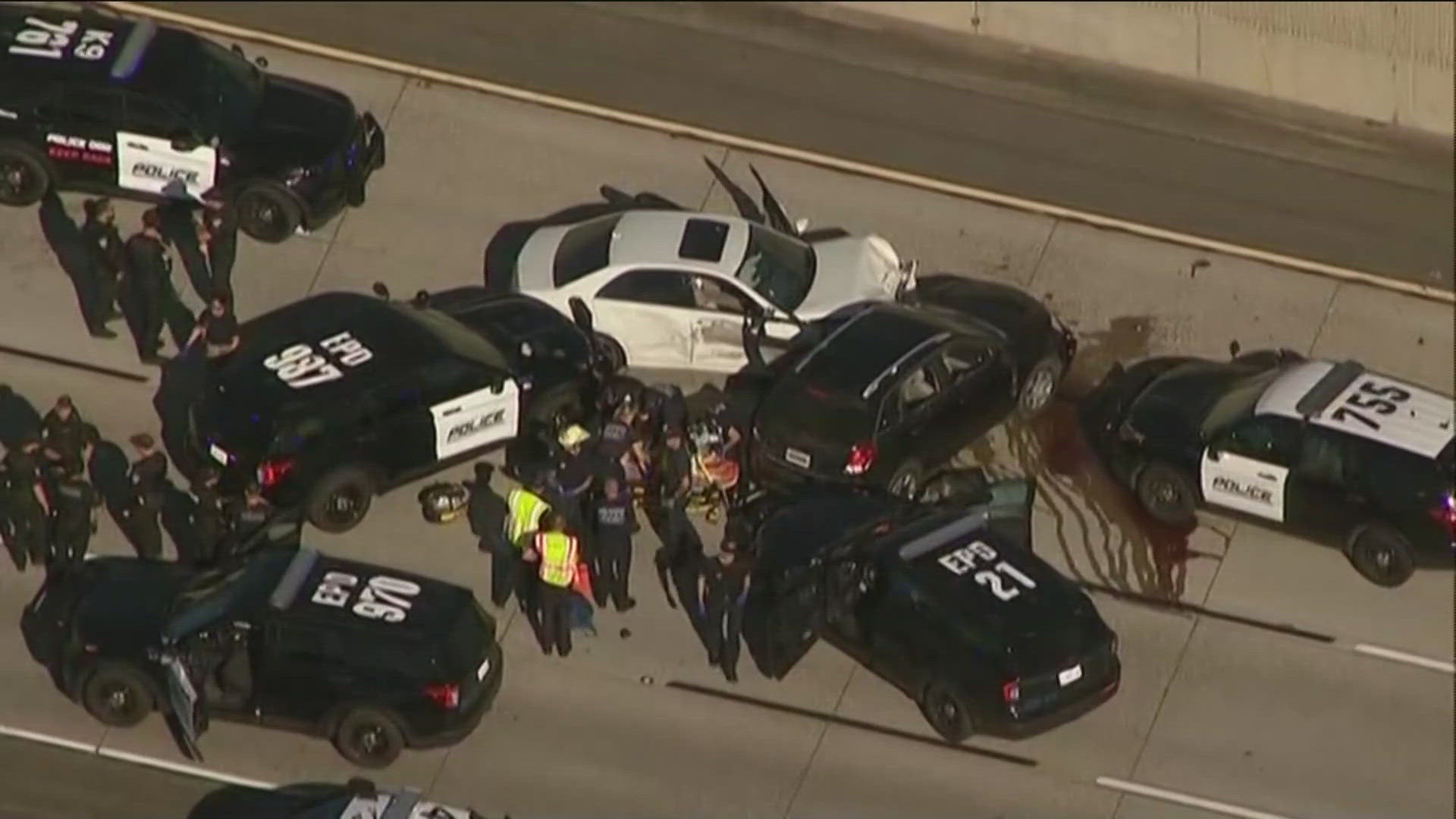 A vehicle pursuit ended in a multi-car crash on I-15 near SR-163, leading to gunfire and at least one person injured.