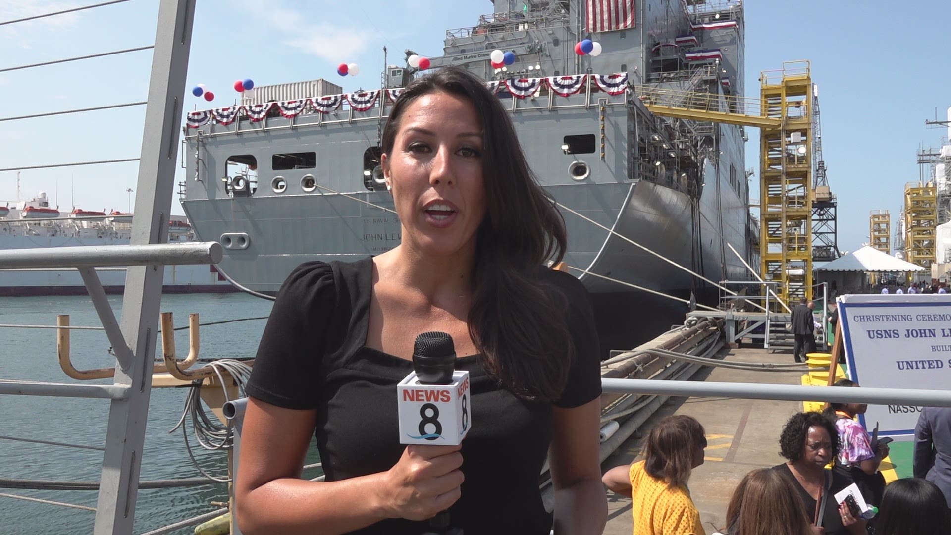 "May God bless this ship and all who serve on it," Woodard said before she broke a bottle of champagne against the replenishment oil ship.