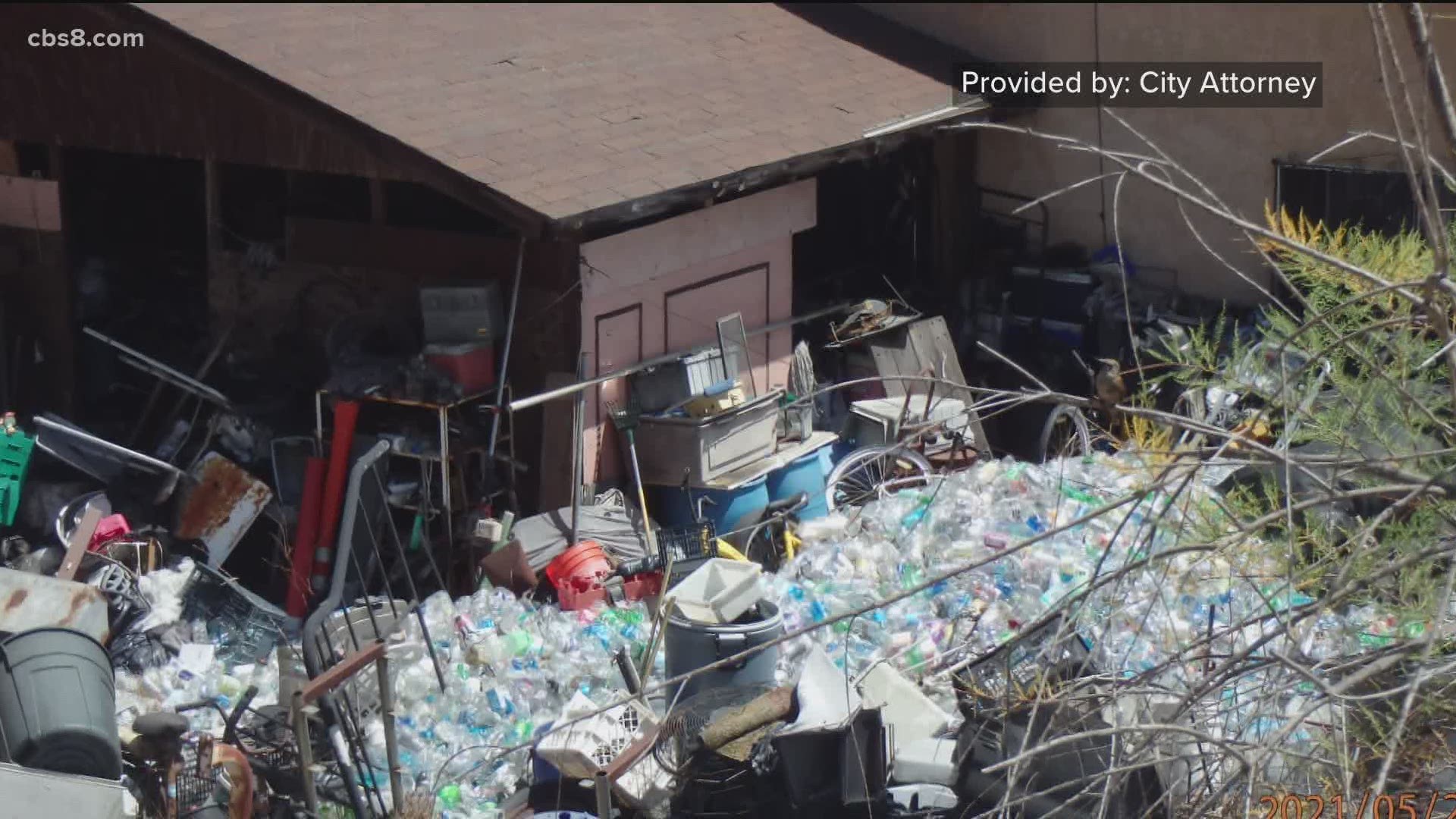Neighbors are complaining about the stench of urine and feces coming from a home in Bay Terraces piled high with trash.