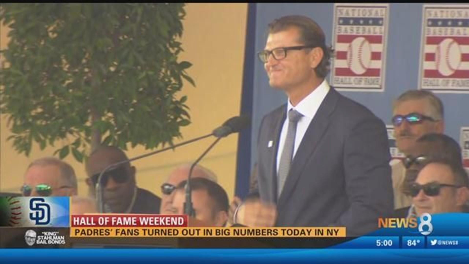 Former San Diego Padres pitcher Trevor Hoffman stands between his wife,  Tracy, and one of his sons as he looks at a standing ovation by fans during  his induction into the Padres