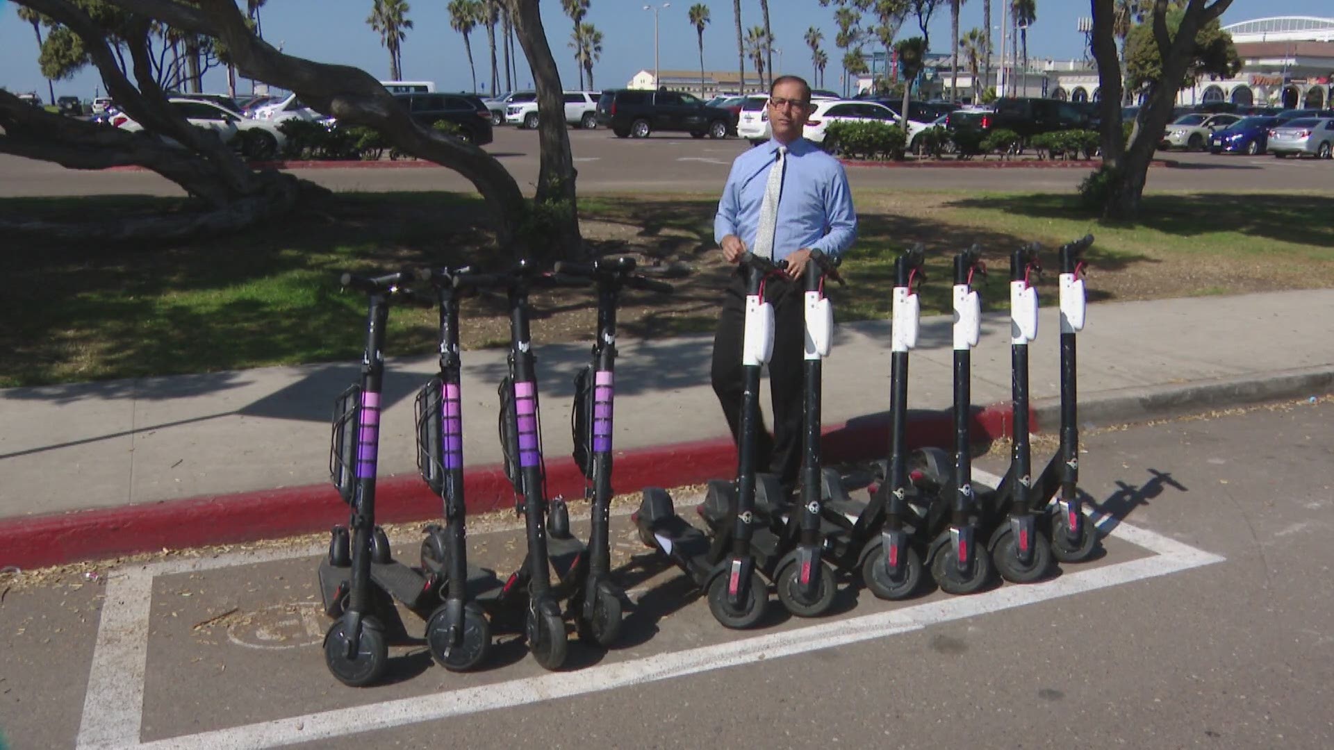 Residents in Mission Beach say scooters in corrals are forcing street sweepers off the curb.