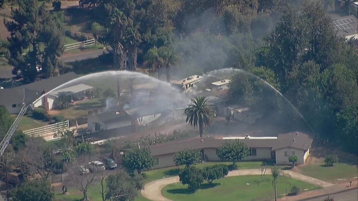 Authorities respond to burning home in El Cajon, possible armed suspect