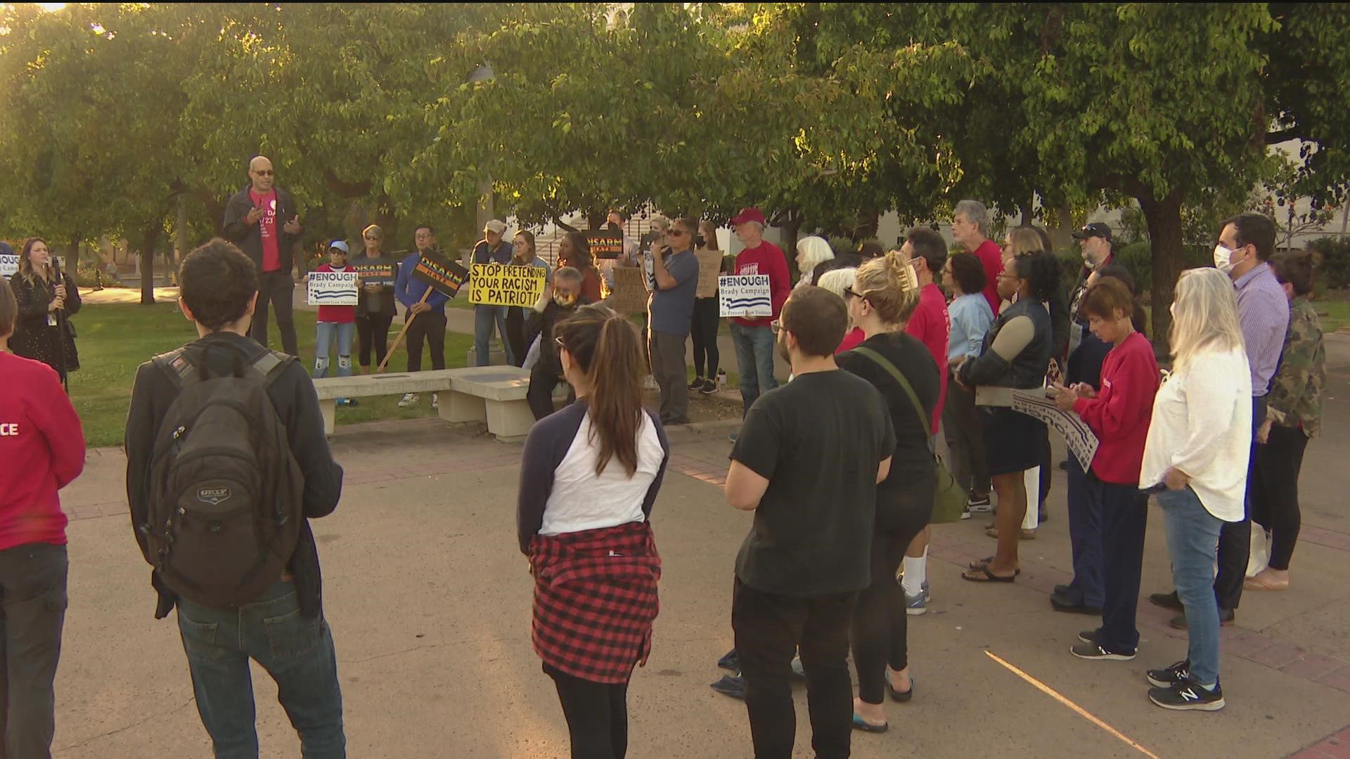 People gathered at Balboa Park Monday evening for a vigil and rally against white supremacy and gun violence.