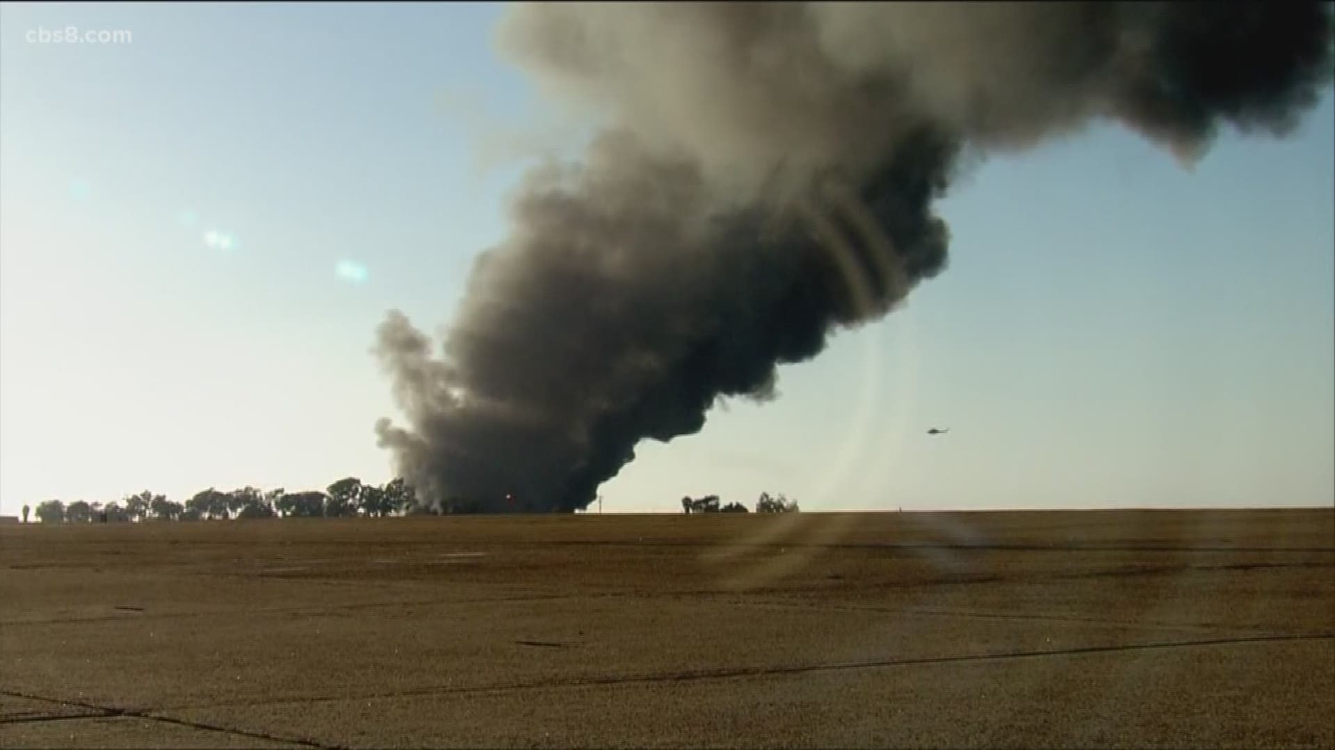 Crews are working to extinguish a fire that is spreading through an auto junkyard in the 900 block of Heritage Road in Otay Mesa, according to the San Diego Fire-Rescue Department. The blaze is sending a large column of black smoke into the sky over the South Bay.