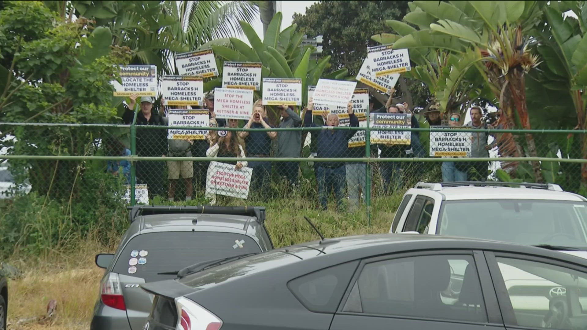 Group, including mayoral candidate Larry Turner, gathered outside H Barracks and yelled at the speakers at the podium.