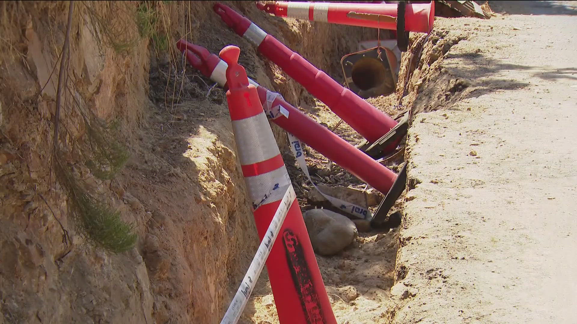 A property owner dug the trench four months ago for a retaining wall, but the work stopped, and neighbors say it's not safe for drivers.