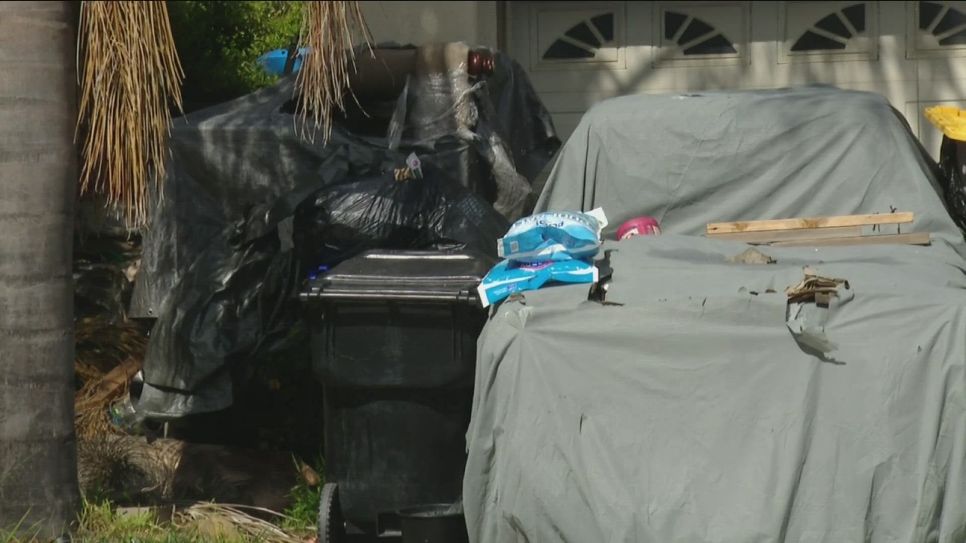 Boxes of trash and furniture can be seen outside the home on Mariner Drive. A neighbor said there is rotting food that attracts rats.