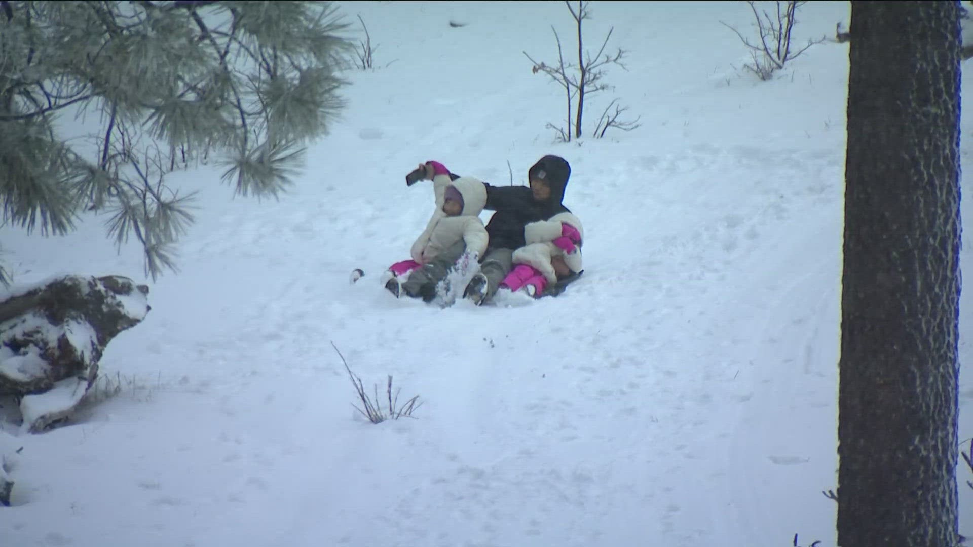 San Diego families traveled to Mount Laguna on Friday to play in the snow. It's expected to stick through Saturday as cold temperatures remain.