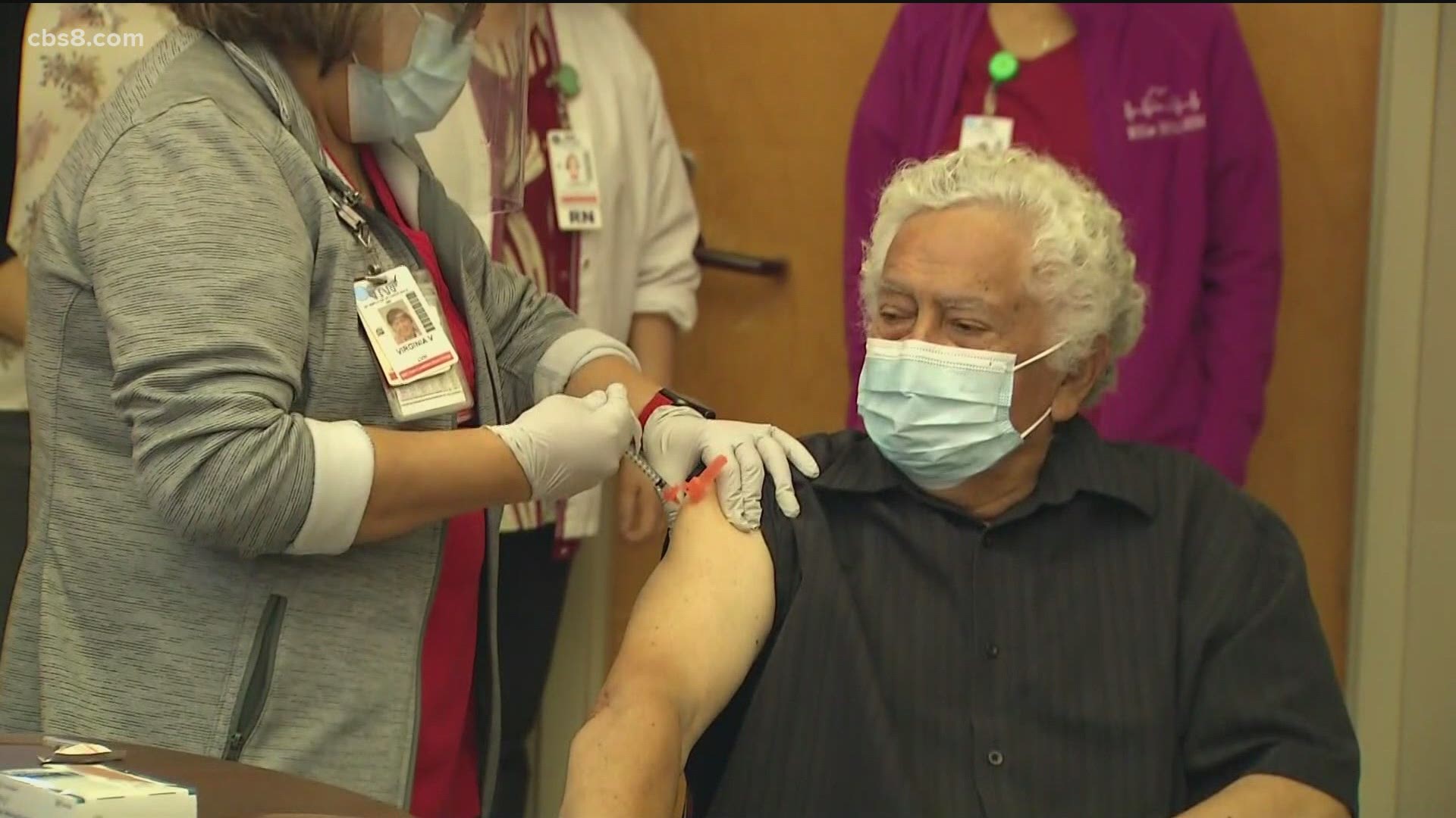 Carlos Alegre was the first person to receive his inoculation amid cheers from staff at the facility.