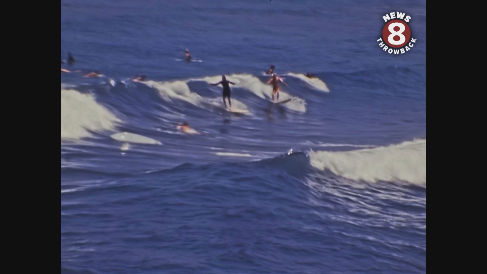 June 12, 1976 Ocean Beach pier and surfers in the ocean blue.