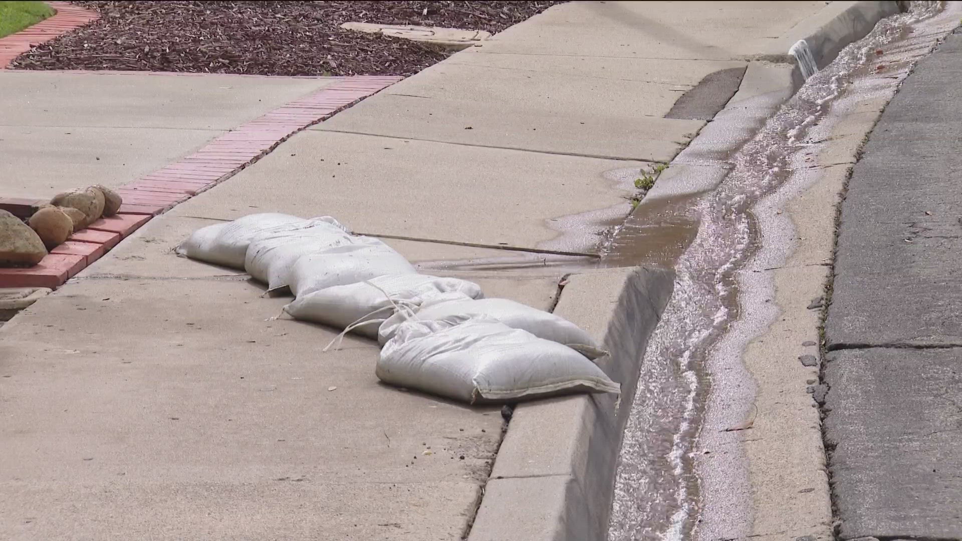 Homeowner has spent thousands trying to fix the problem on her own. She installed a drain in her driveway, bought a pump, and even lined her home with sandbags.