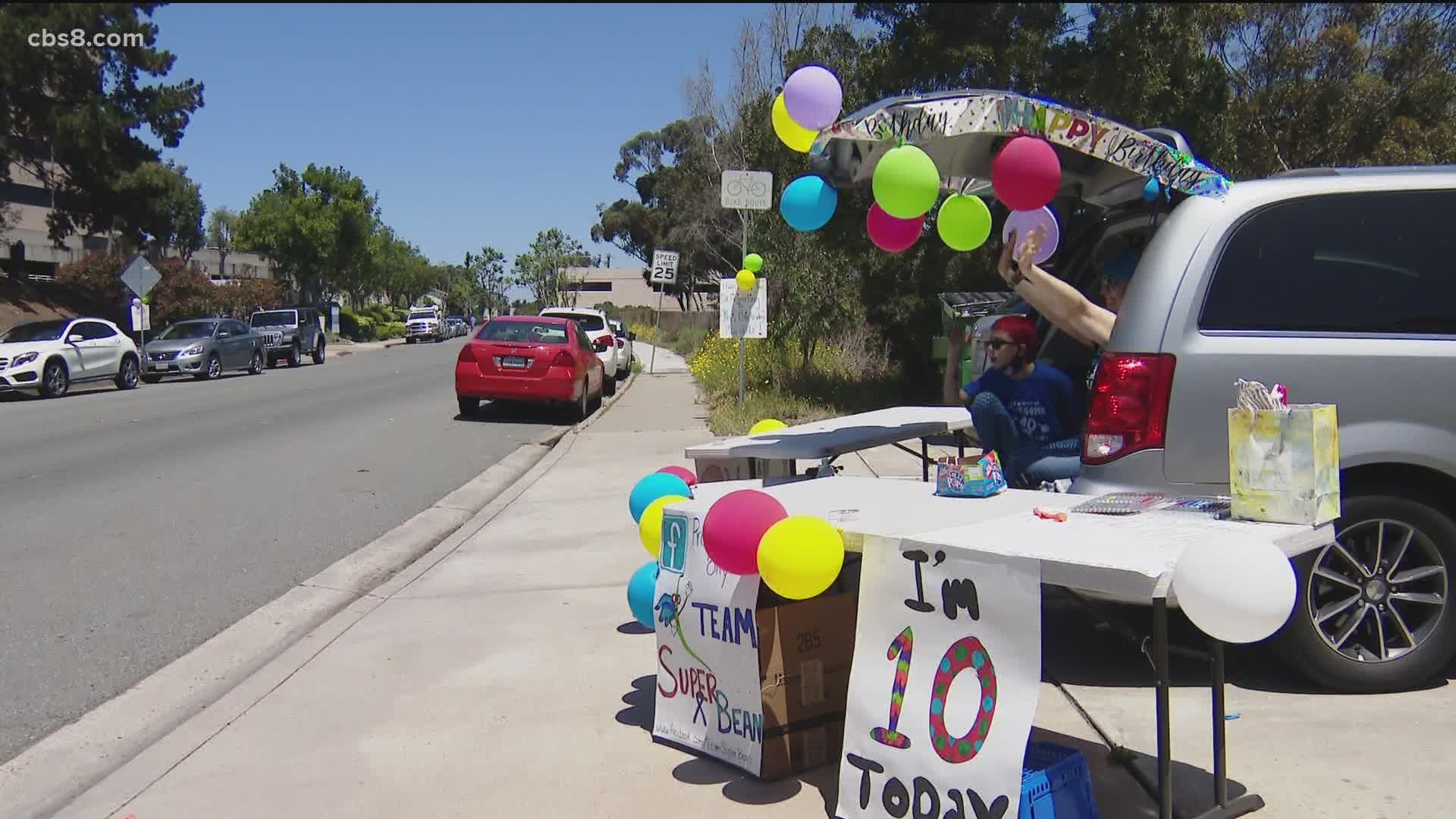 Drive-by parade celebrates 10th birthday for boy whose parents were ...