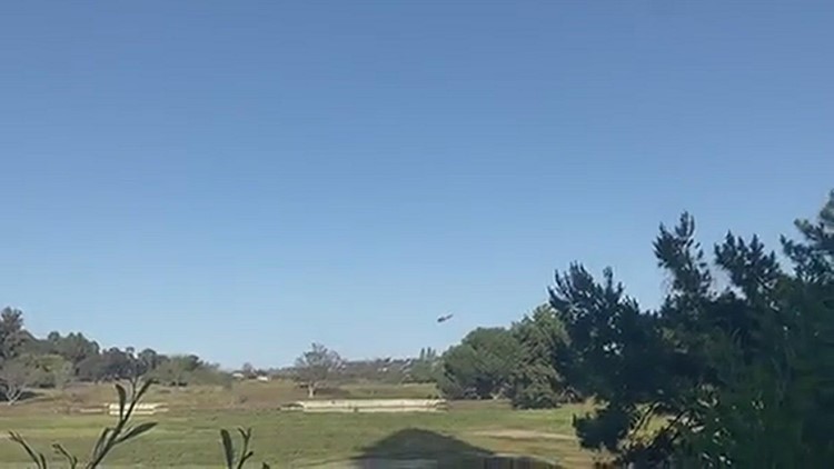 Helicopter gathering water at Riverwalk golf course for Presidio fire