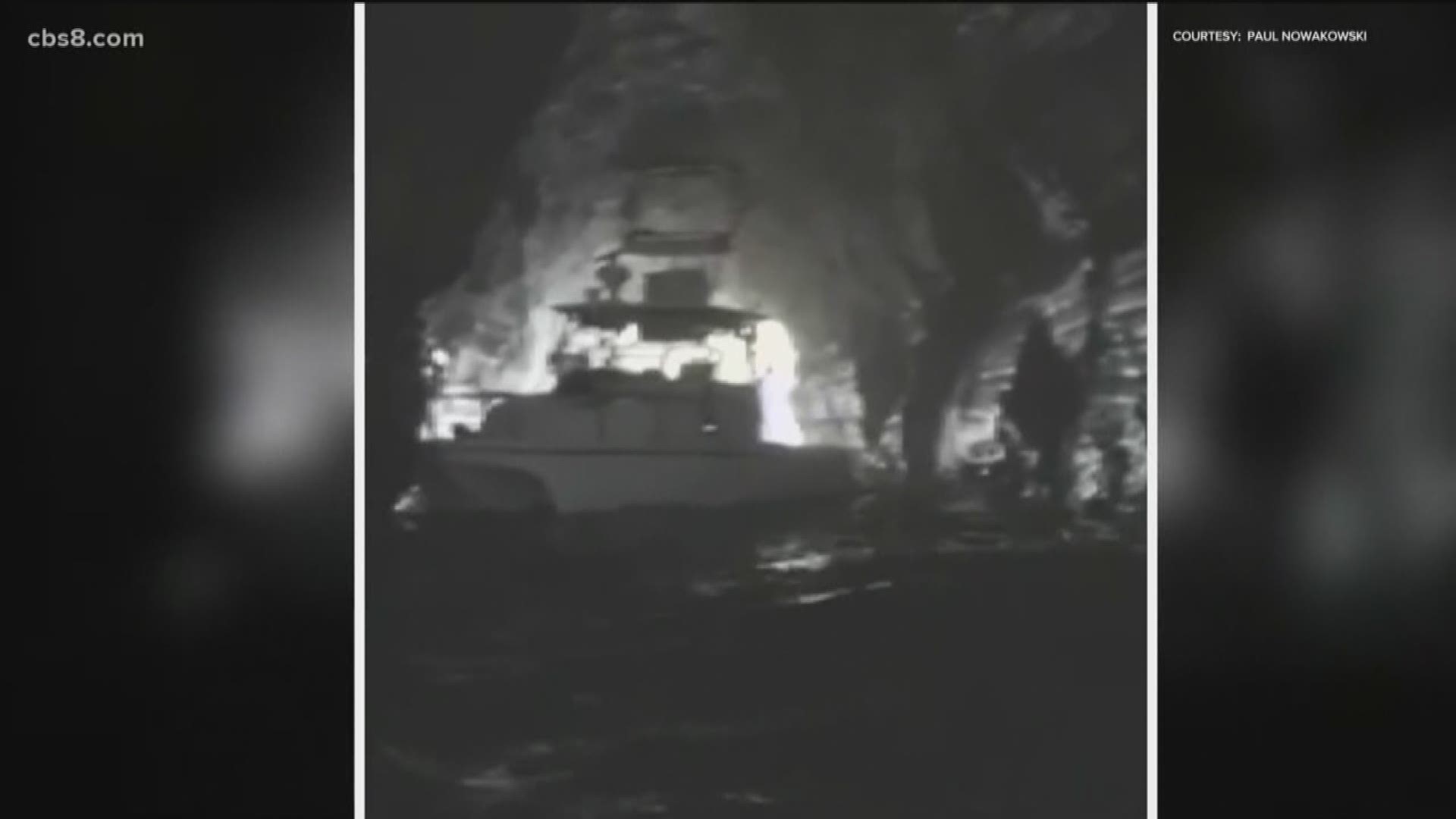 Lifeguards rescued two men after they fell asleep on a boat and awoke to find themselves inside a cave.