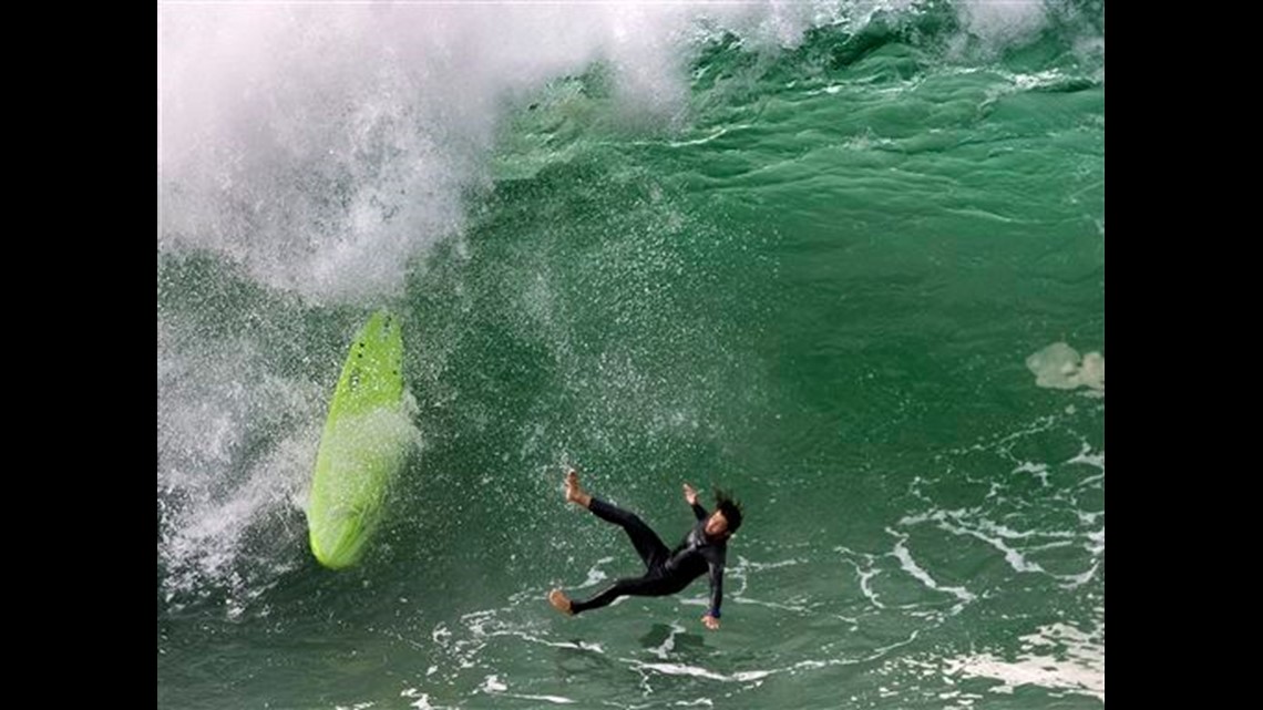 Spectators and surfers flock to the coast as mega swell continues