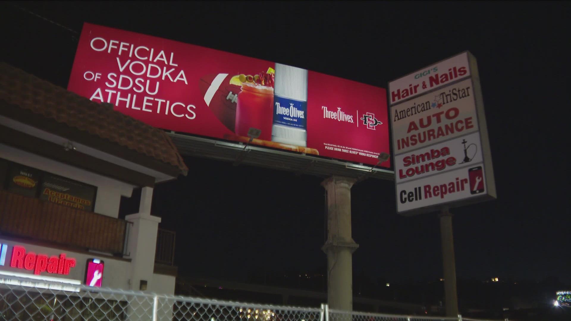 A vodka billboard near San Diego State University advertising its partnership with SDSU Athletics is drawing criticism considering recent alleged criminal events.