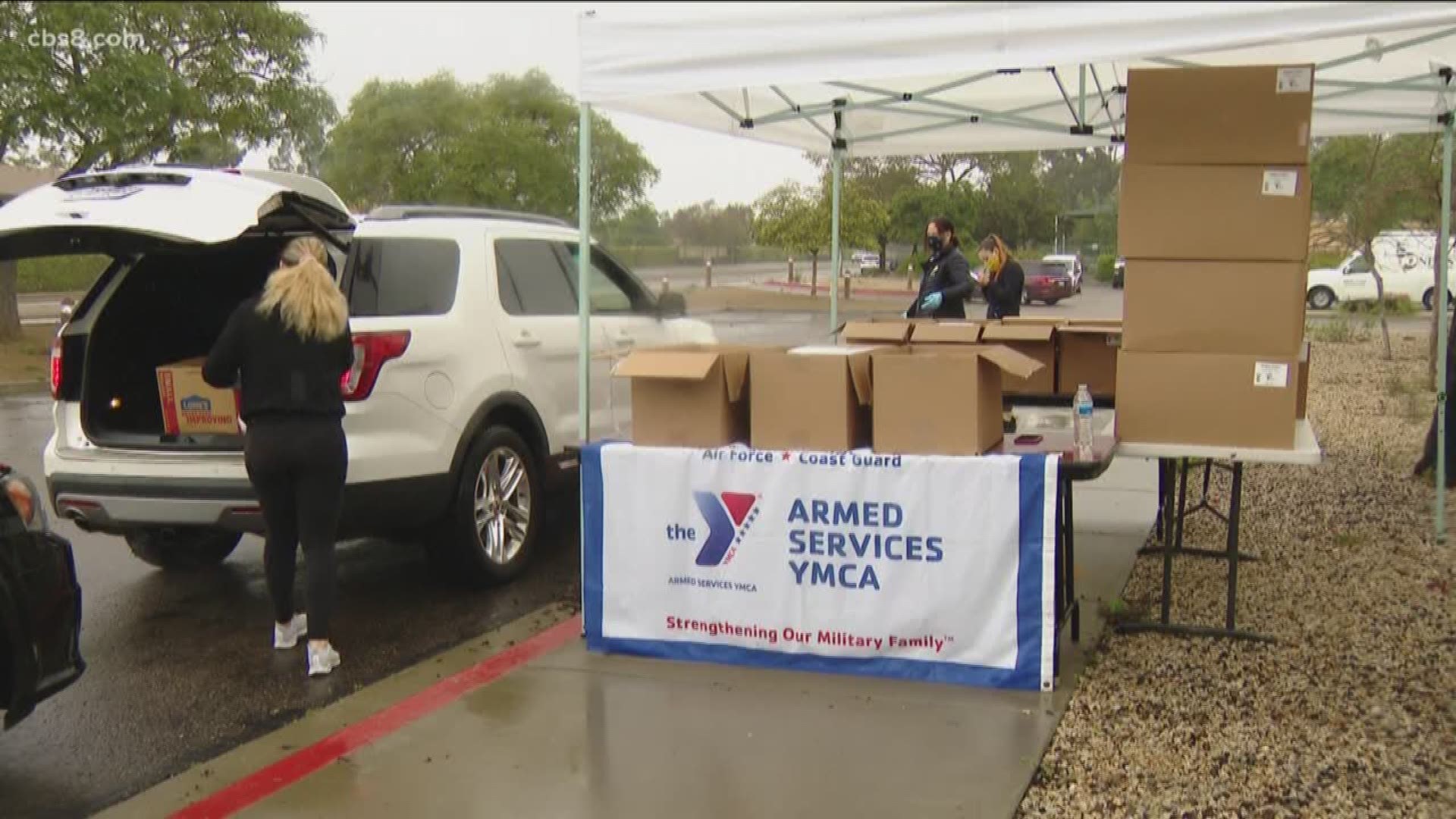The Armed Services YMCA San Diego distributed 350 food boxes to military families via drive-thru pick-up to support social distancing on Monday.
