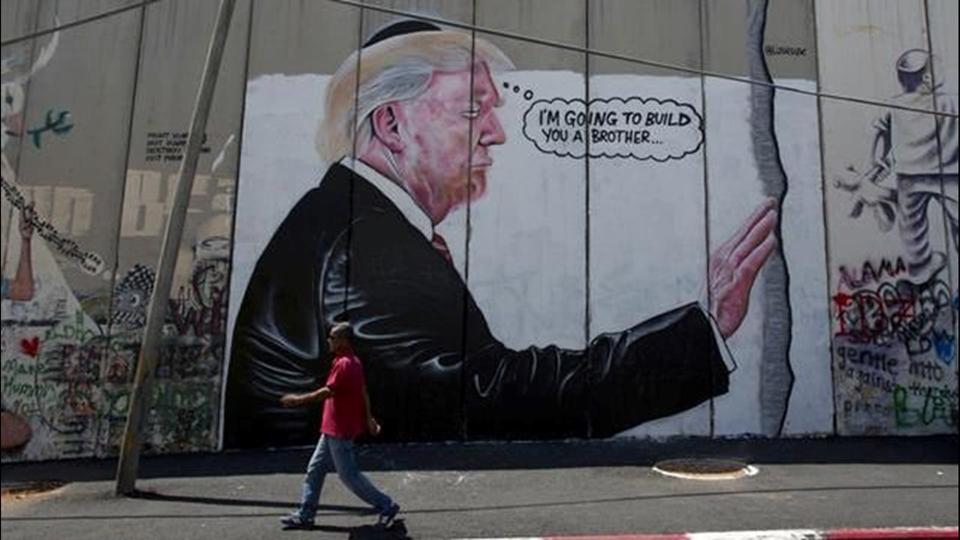 2 huge Trump murals appear on West Bank barrier | cbs8.com