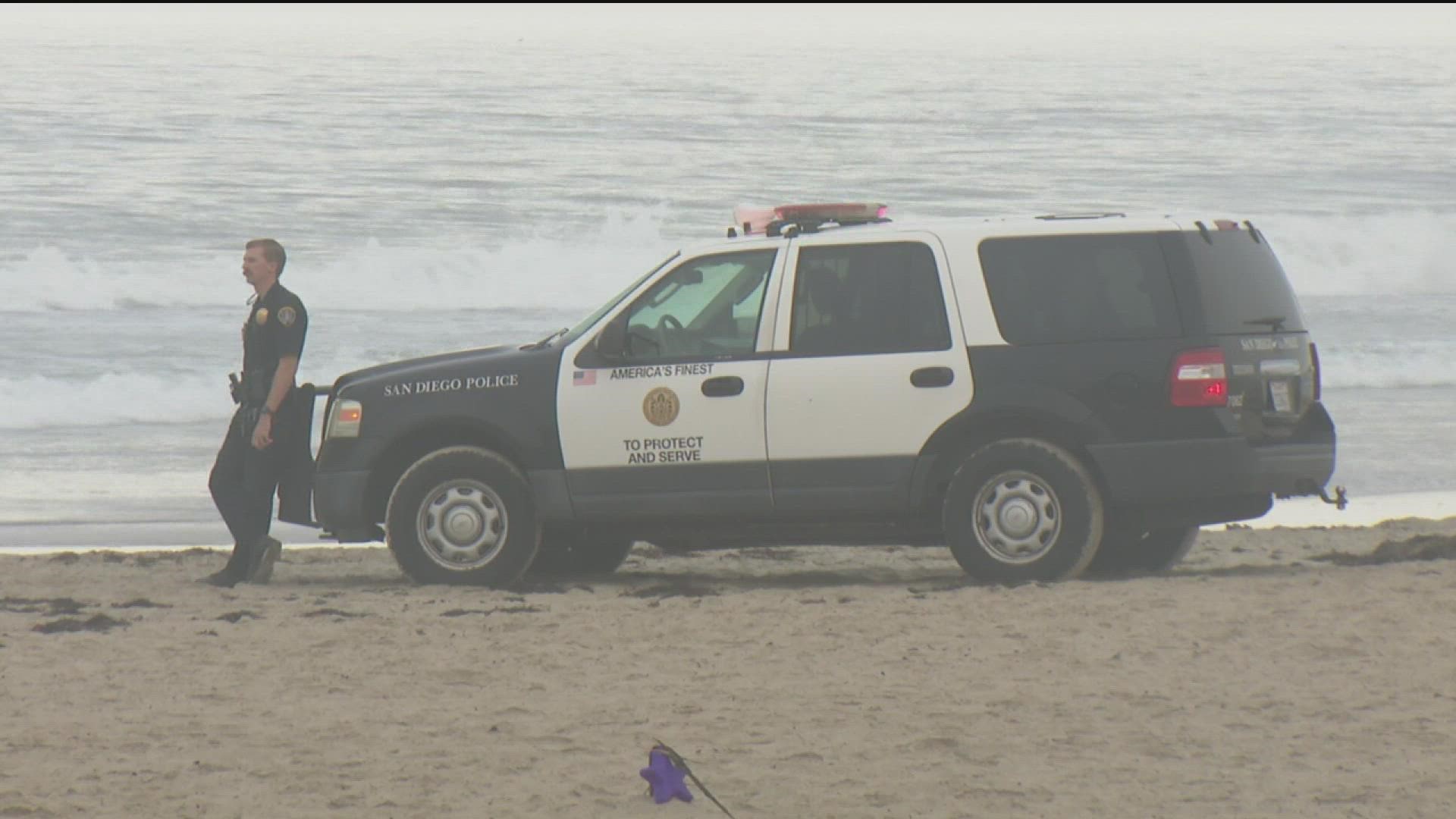 Police say people found a woman on the sand suffering from a gunshot wound around 12:30 a.m.