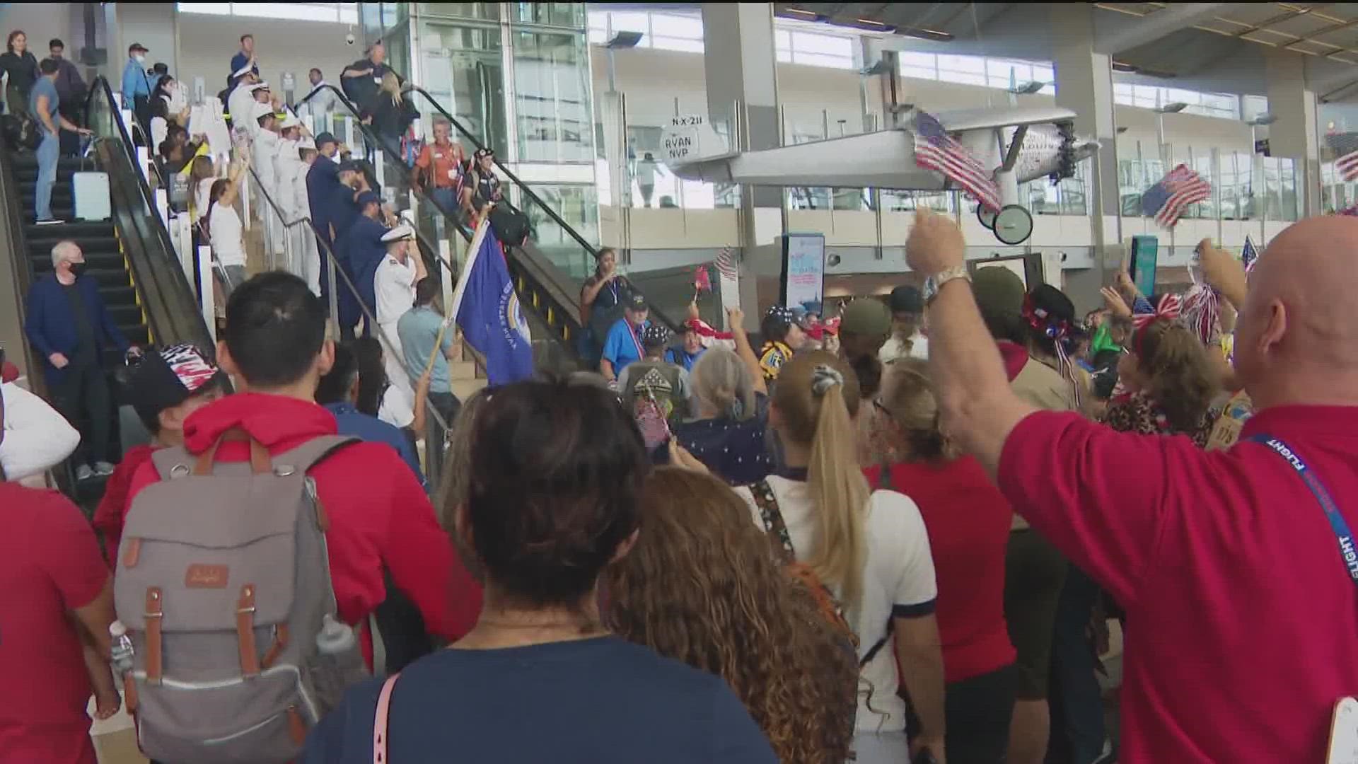 Nearly 1,000 people lined up at San Diego International Airport to welcome Honor Flight back from Washington D.C.