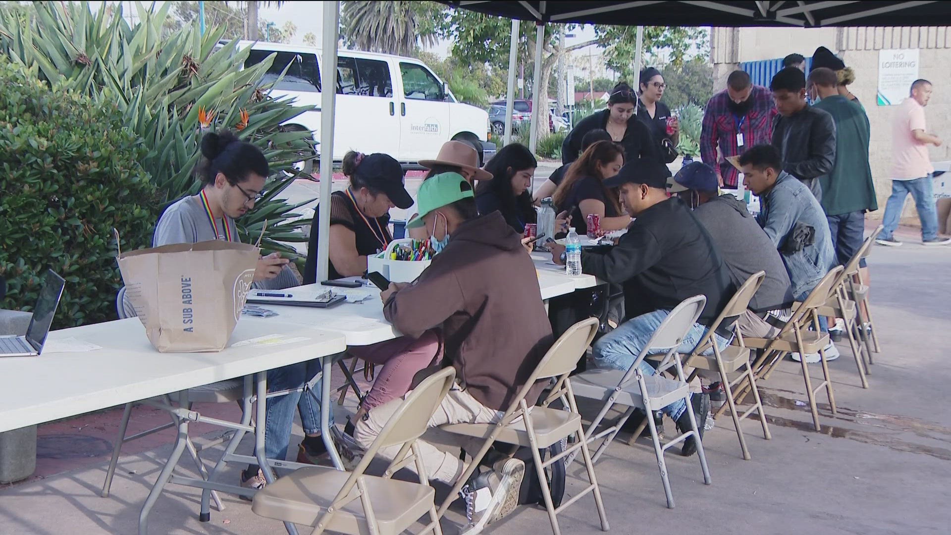 Interfaith Community Services, a local nonprofit, has tents set up to help with the intake process and connect migrants with sponsors, friends and family in the U.S.