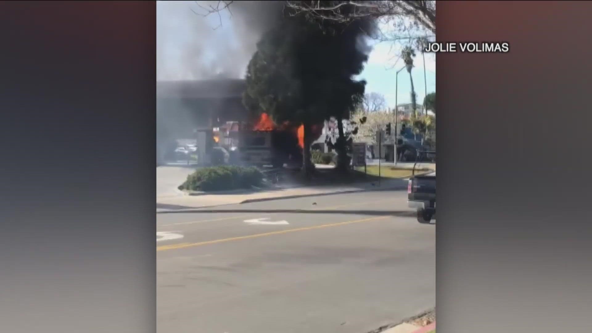Authorities are investigating what led to an RV allegedly exploding and catching fire at a La Mesa gas station, leaving two people with burn injuries.