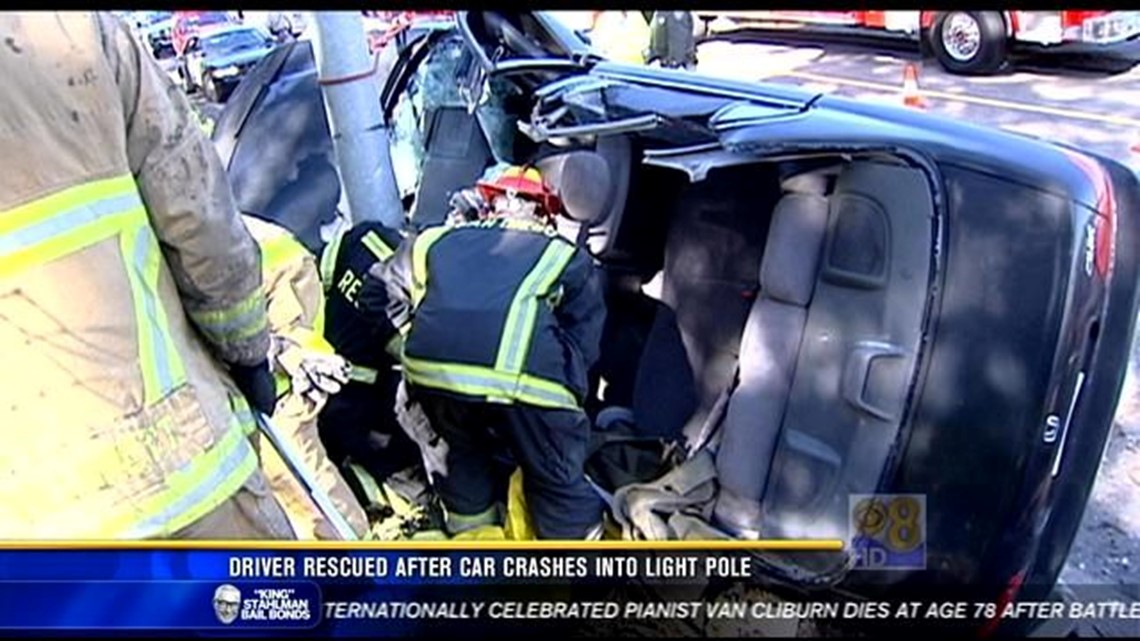 Driver rescued after crashing car into light pole | cbs8.com