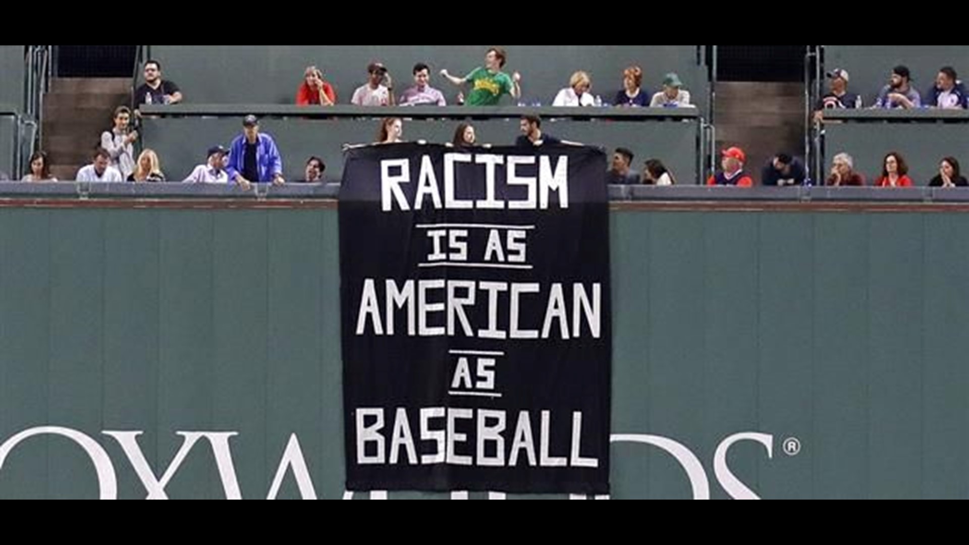 Fans denounce racism with sign above Green Monster | cbs8.com