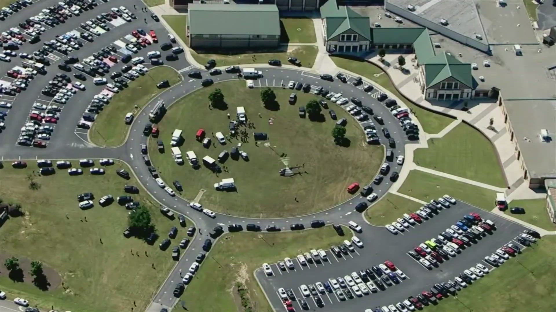 Helicopter video showed dozens of law enforcement and emergency vehicles surrounding the high school about 50 miles northeast of Atlanta.